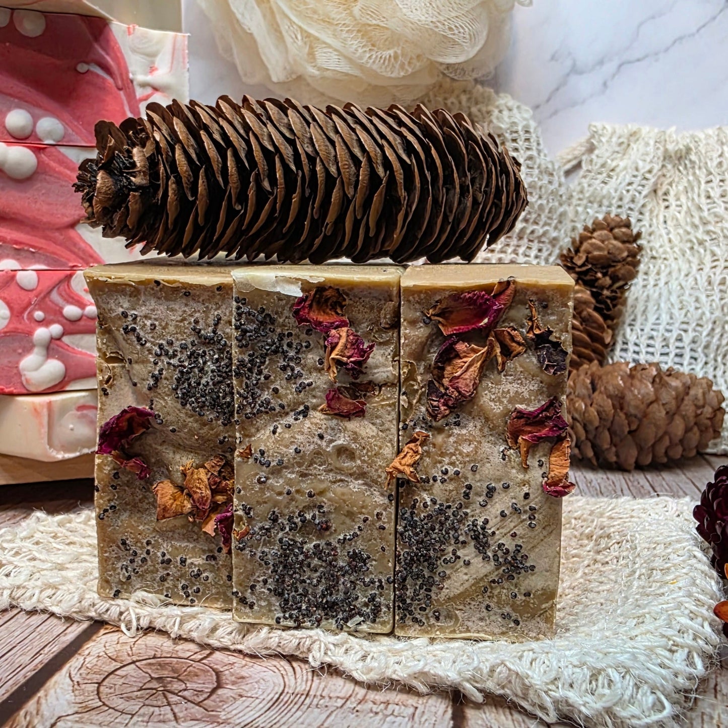 soap bars with natural elements on a wooden surface