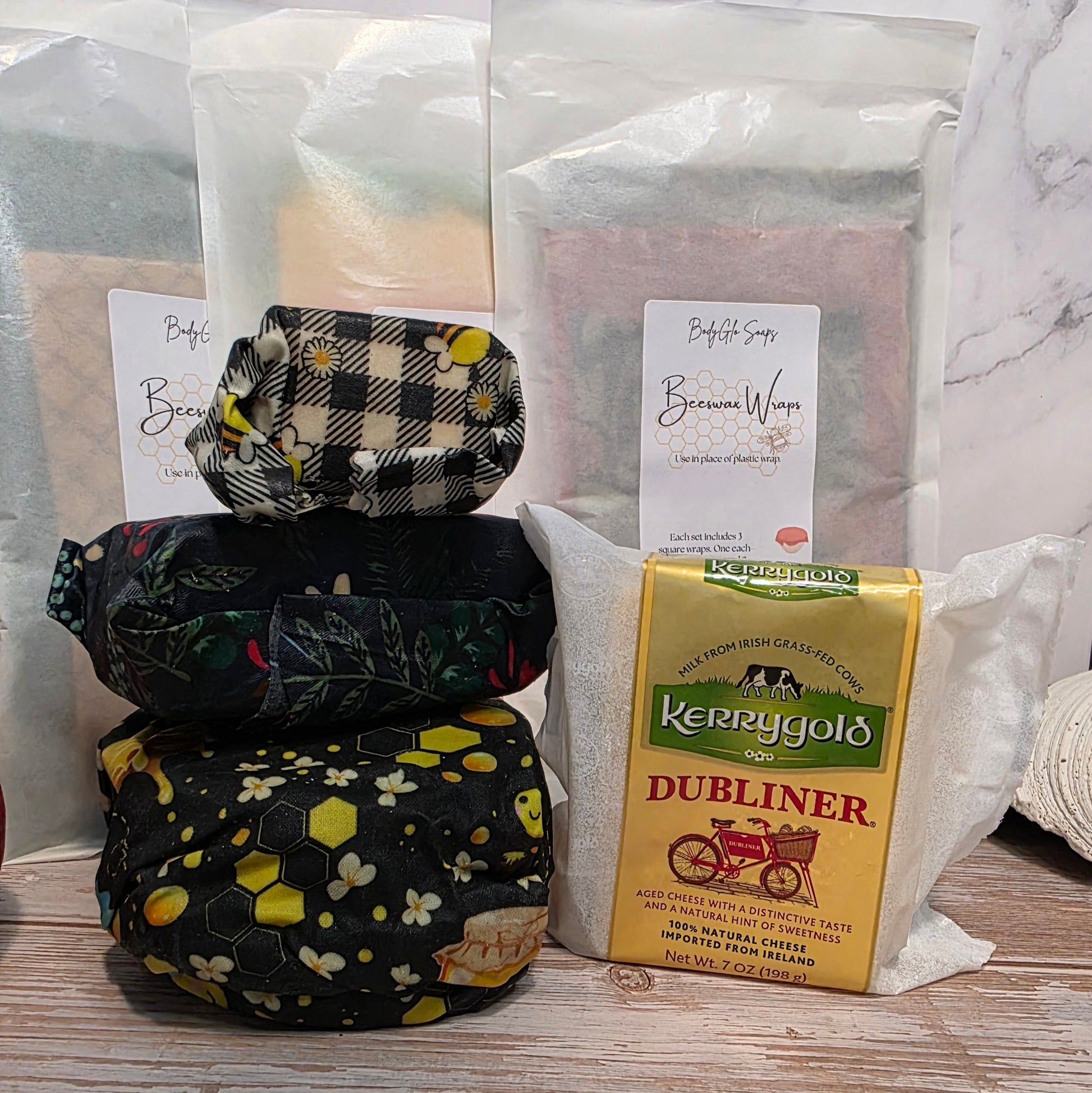 Stack of beeswax wraps with Kerrygold Dubliner cheese packaging on a marble surface