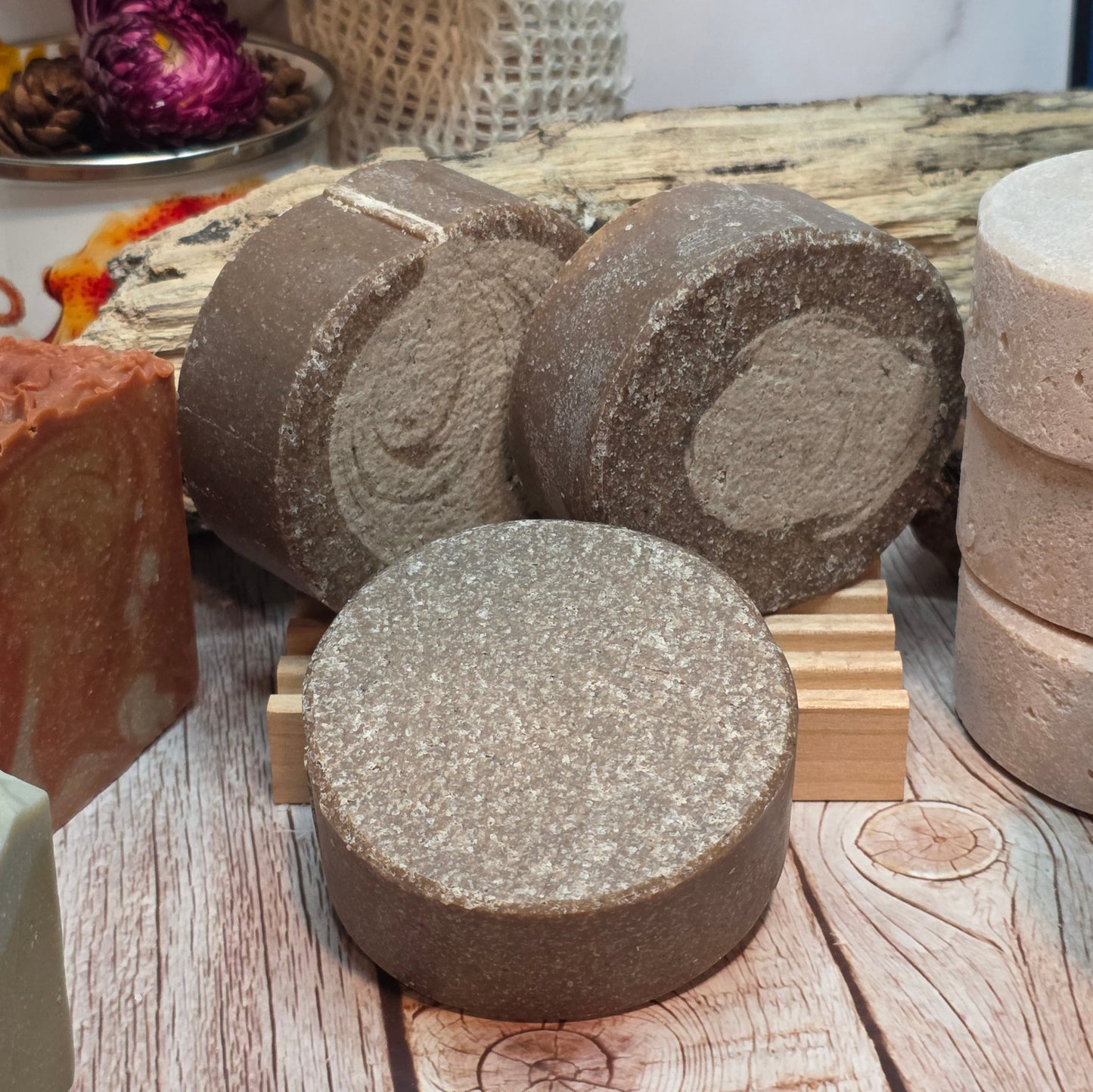 Various types of soap on a wooden surface with a blurred background