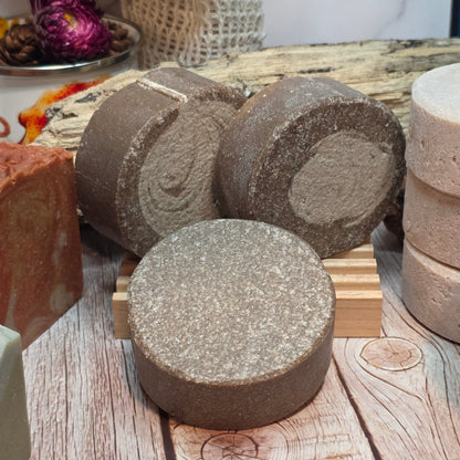 Various types of soap on a wooden surface with a blurred background