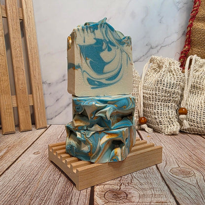 Marble-patterned soap bars on a wooden stand with a marble background